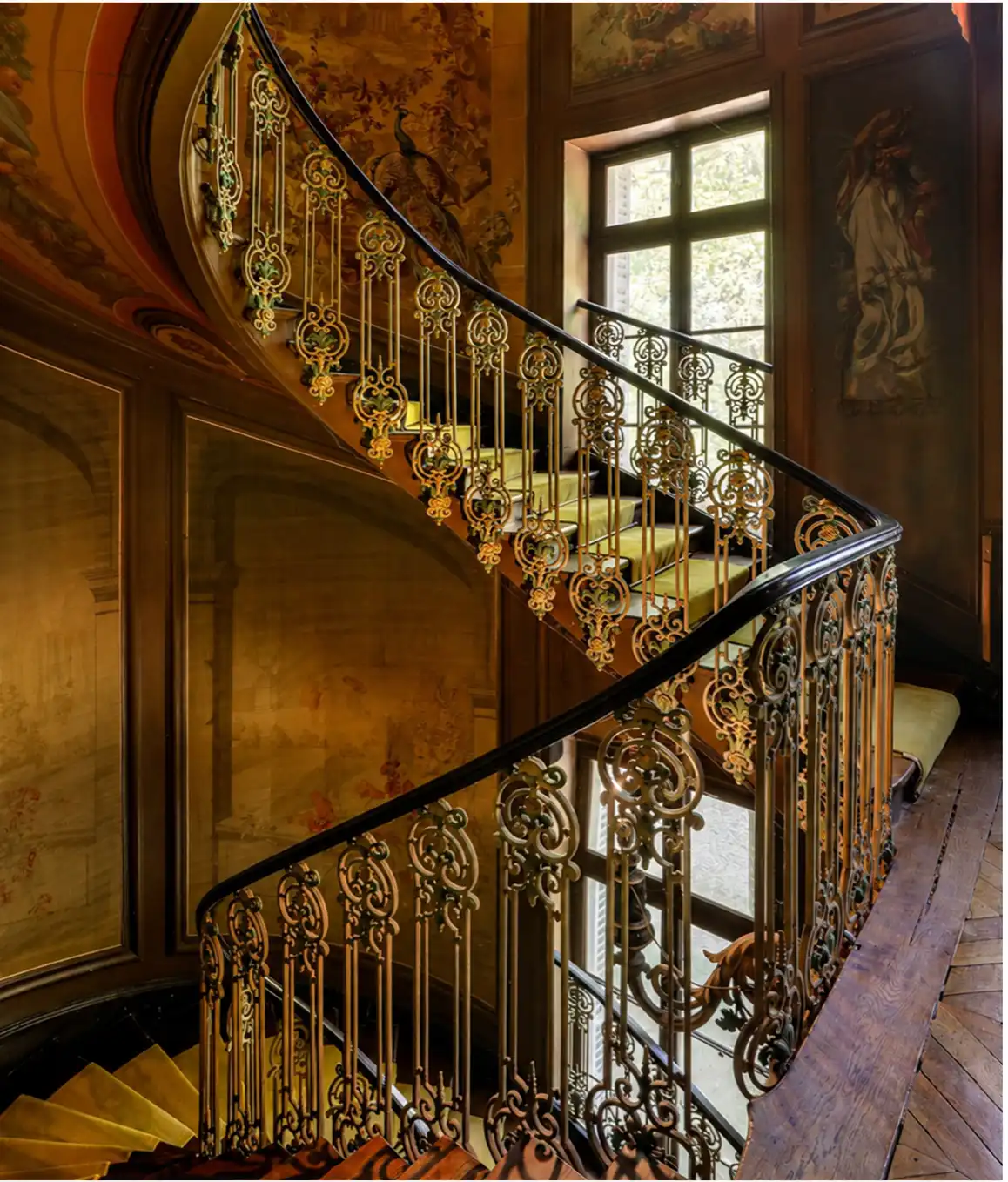 The château's wrought-iron grand staircase, a filming location